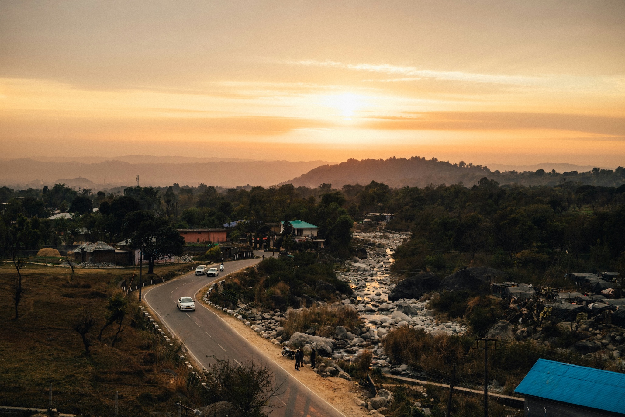 Winding road and river valley near Dharamshala at sunset