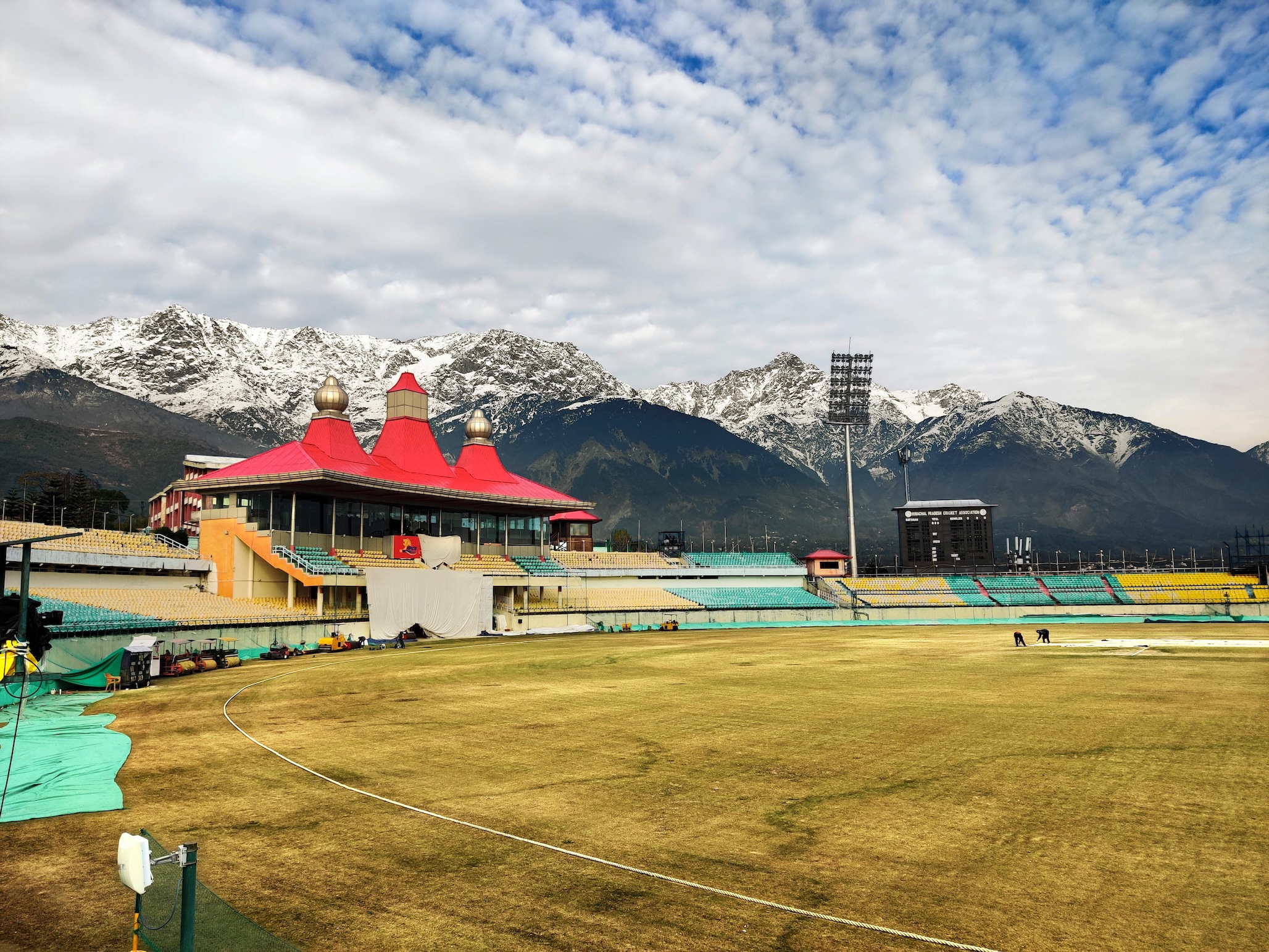 Dharamshala cricket stadium with snow-capped Dhauladhar mountains in the background