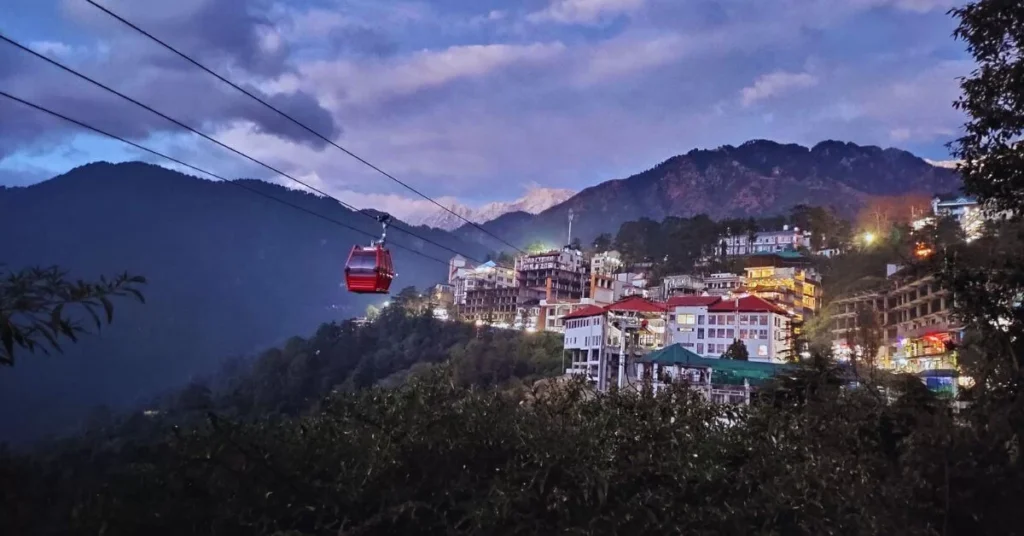 Dharamshala–McLeod Ganj ropeway moving through rain-filled monsoon clouds in the hills