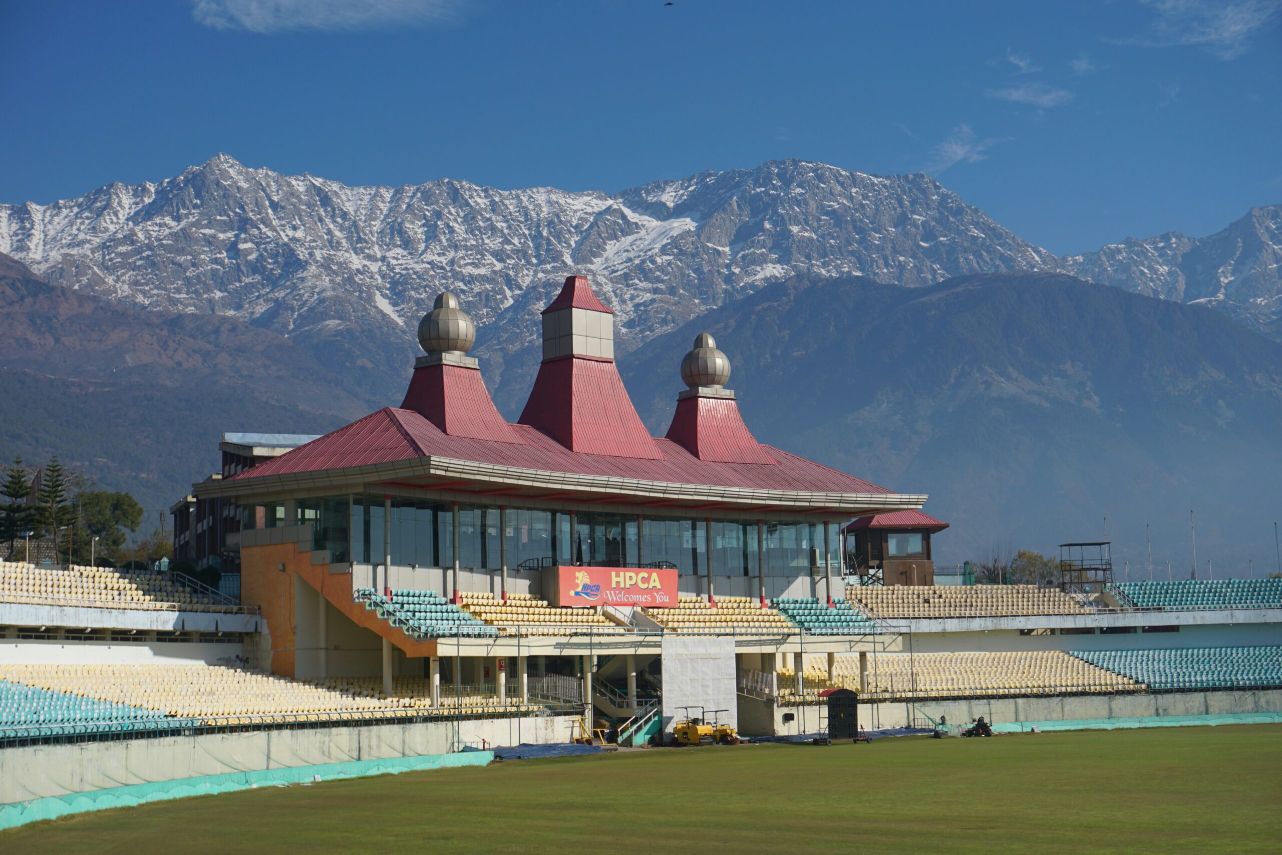 Dharamshala cricket stadium set against the snow-capped Dhauladhar mountains