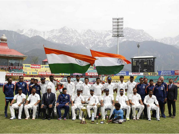 Indian cricket team posing at Dharamshala cricket stadium with the Dhauladhar mountains in the background