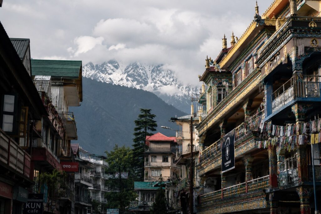 Best places to visit in Dharamshala featuring a traditional Tibetan temple and street scene in McLeod Ganj