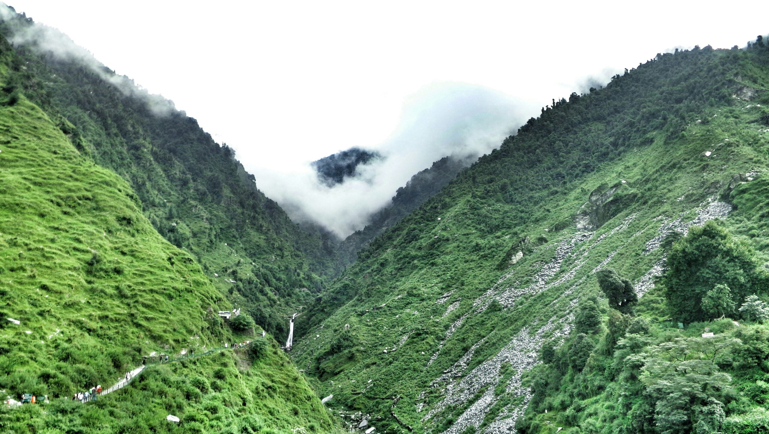 Valley view of Bhagsu Nag Waterfall surrounded by green hills in Dharamshala