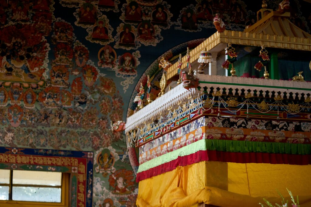 Interior view of the Dalai Lama Temple with ornate Tibetan Buddhist artwork in McLeod Ganj, Dharamshala