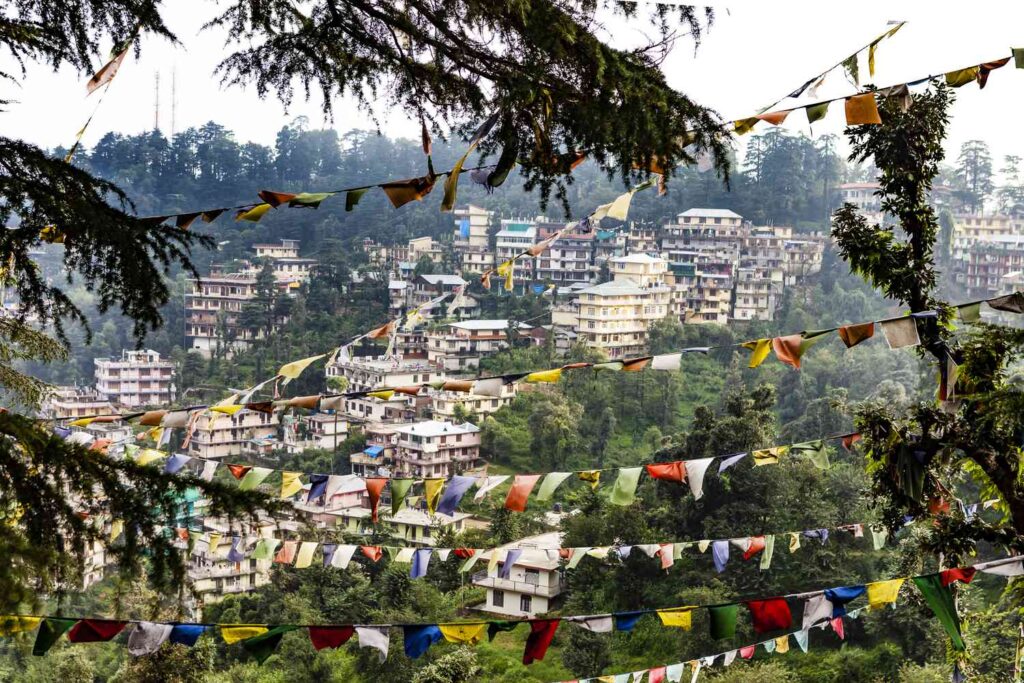 View of McLeod Ganj town in Dharamshala surrounded by the Dhauladhar mountains