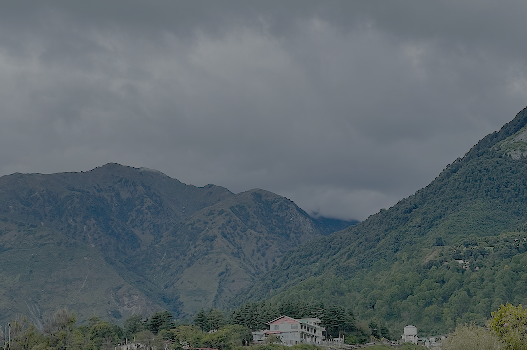 Green hills and mountain slopes of Khaniyara area town cloudy skies