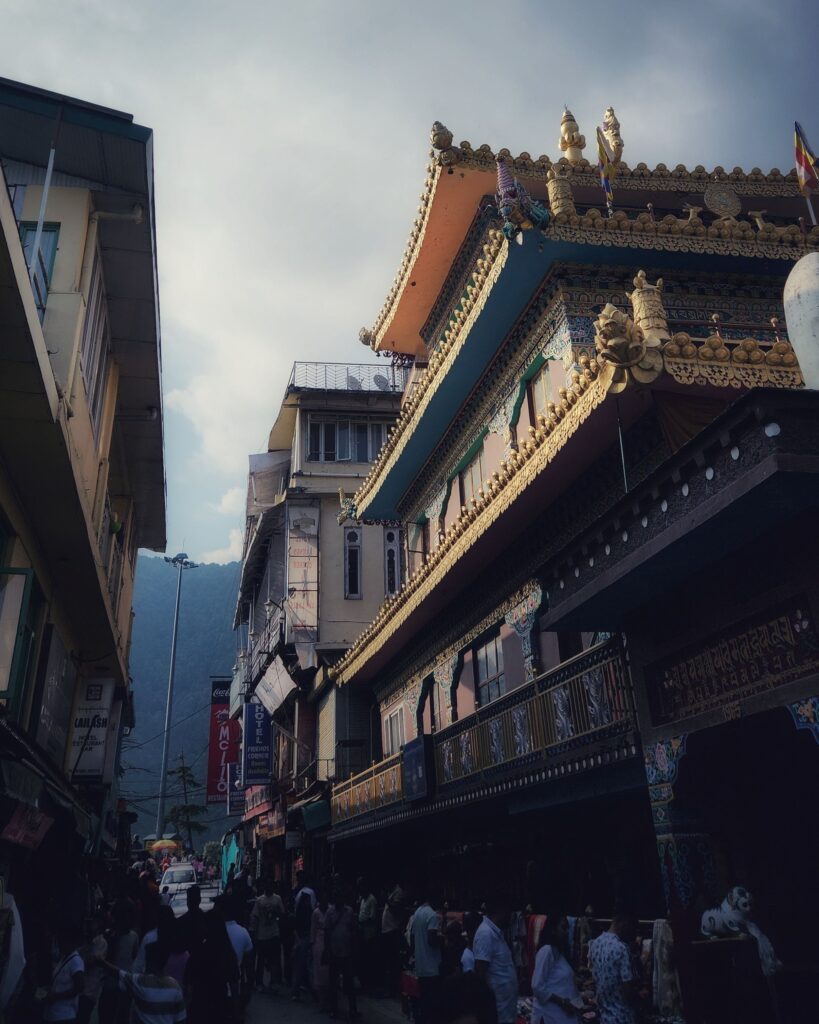 Street view of McLeod Ganj market with Tibetan monastery architecture in Dharamshala