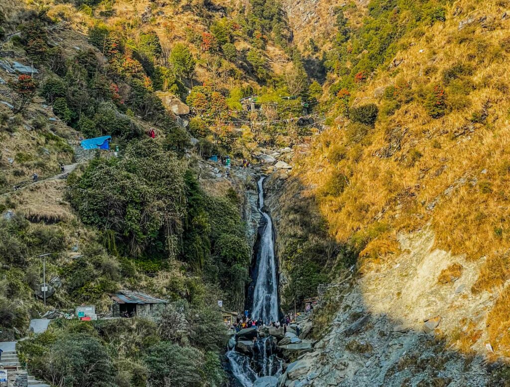 Bhagsu Waterfall near McLeod Ganj surrounded by forested hills, a popular stop while trekking in Dharamshala