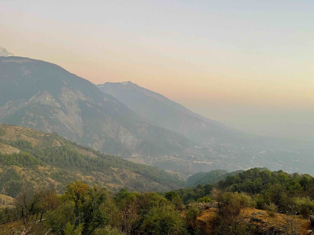 Panoramic mountain view from Bangotu village in Dharamshala with layered hills and sunset sky