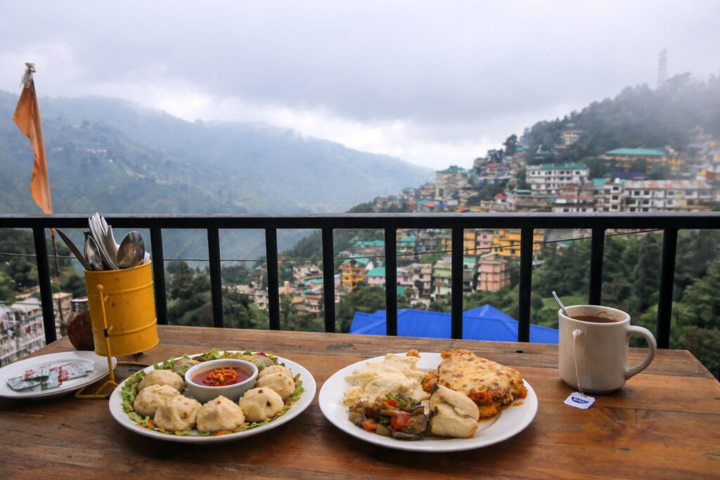 momos with mountain view from a cafe in Dharamshala overlooking hillside town