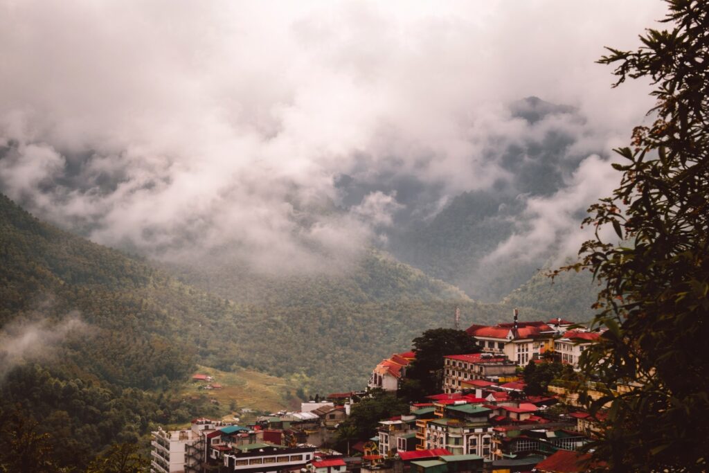 cost of living in Dharamshala affected by monsoon weather with fog covering mountain town