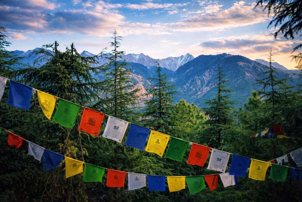 Scenic view of Dhauladhar mountains with prayer flags in Dharamshala showing the journey and routes on how to reach Dharamshala