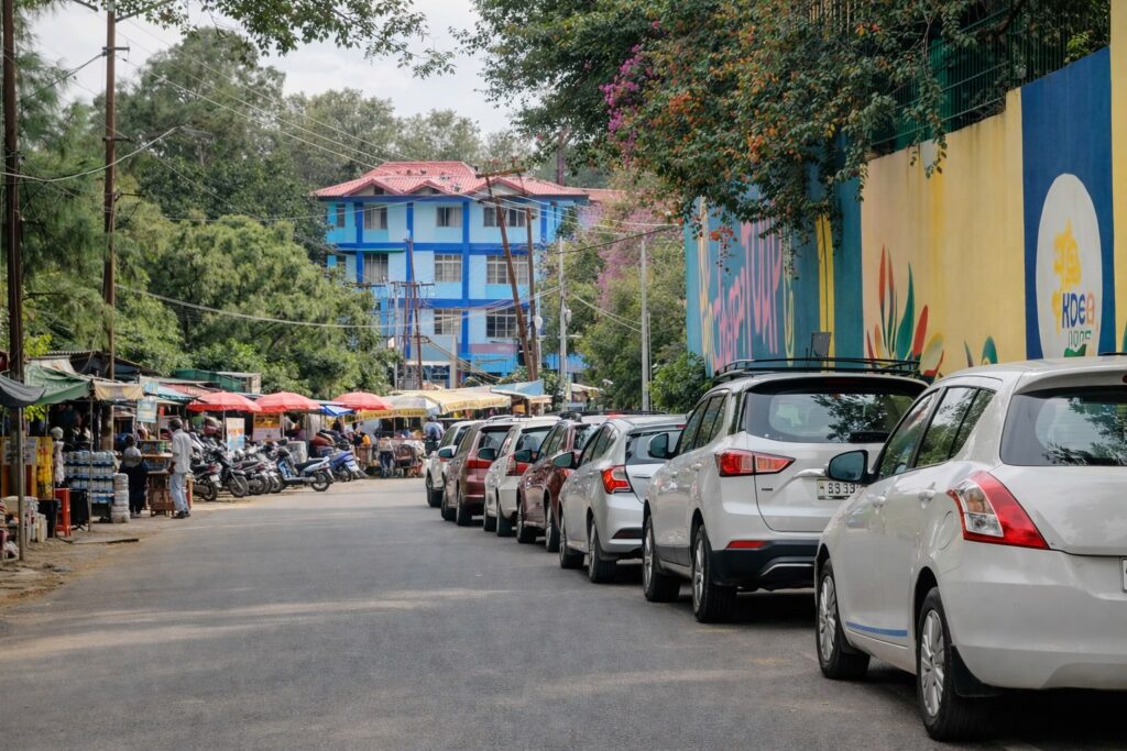 Traffic and parked cars on a Dharamshala road near HPCA Stadium during Dharamshala IPL match 2026