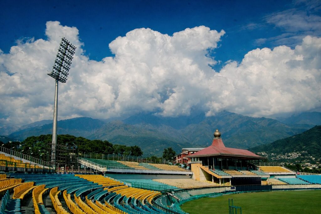View from the stands at HPCA Stadium showing seating layout and Dhauladhar mountains during Dharamshala IPL match 2026