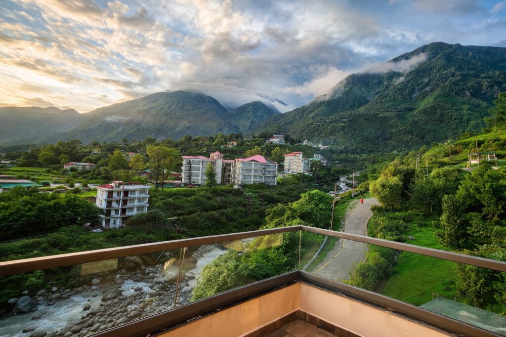 balcony view from a homestay in Dharamshala overlooking valley, mountains and river