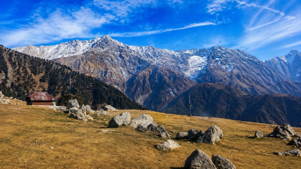 Triund Trek Dharamshala Dhauladhar mountain view with open meadow and rocky landscape