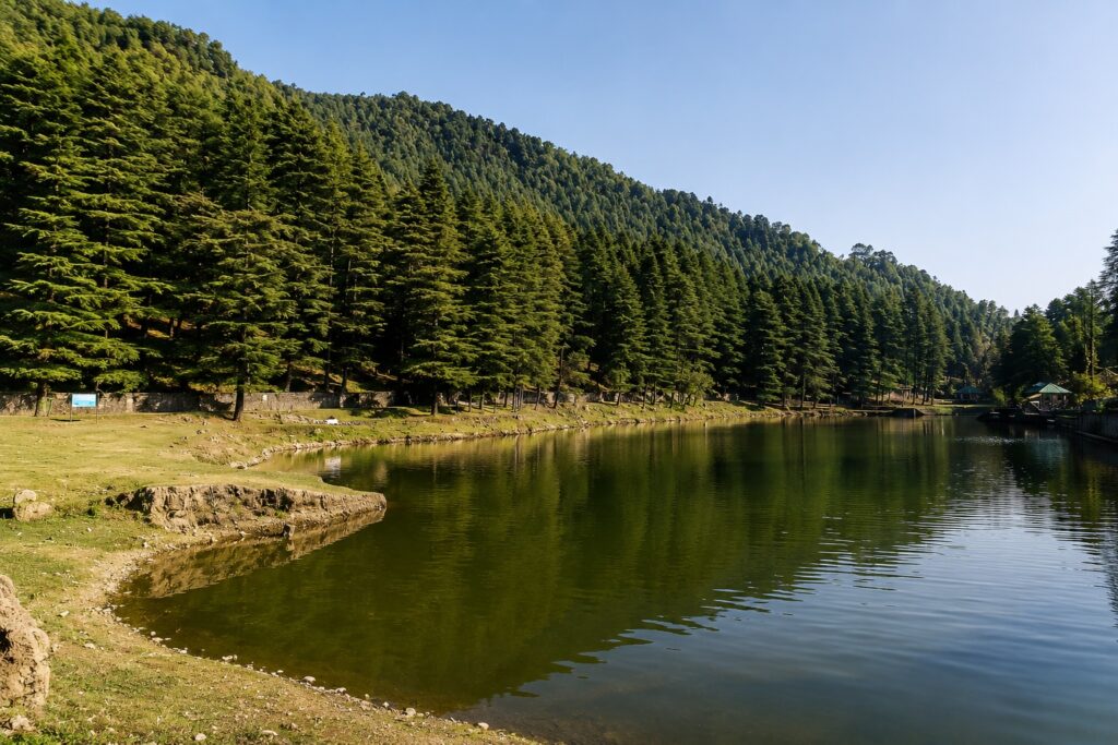 Dharamshala in June at Dal Lake surrounded by deodar forests and calm mountain scenery