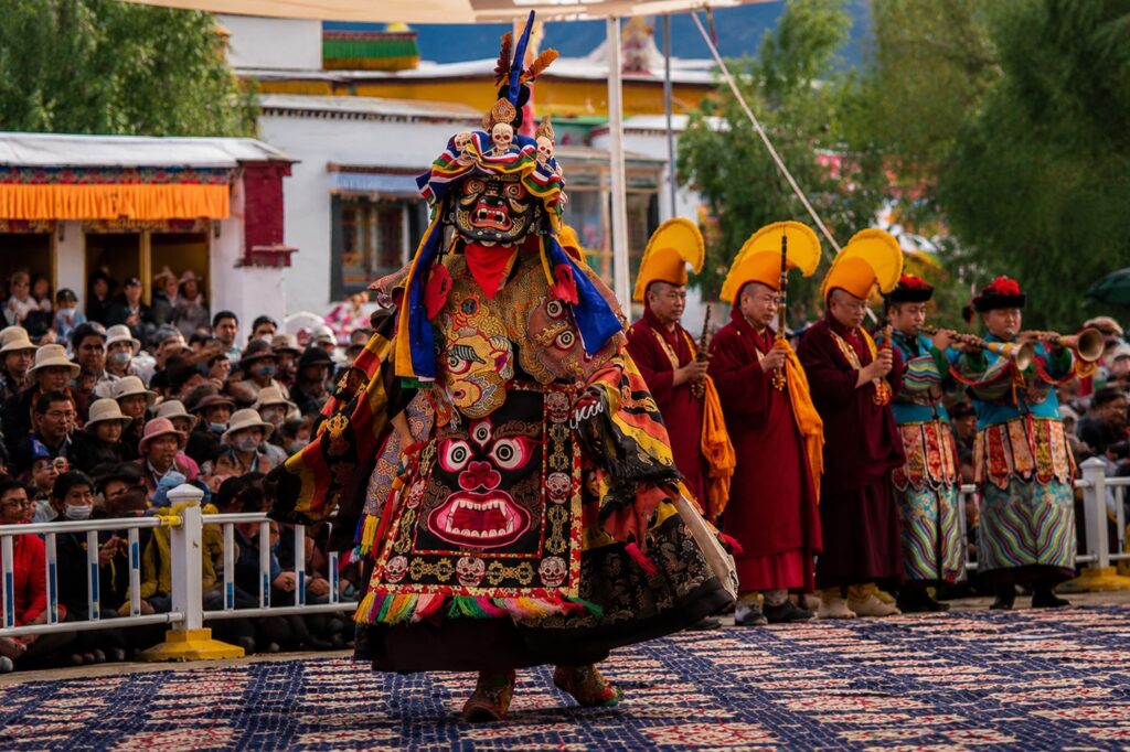 Traditional masked cham dancer performing during a drubchen festival at Chokling Monastery in Bir, Himachal Pradesh.