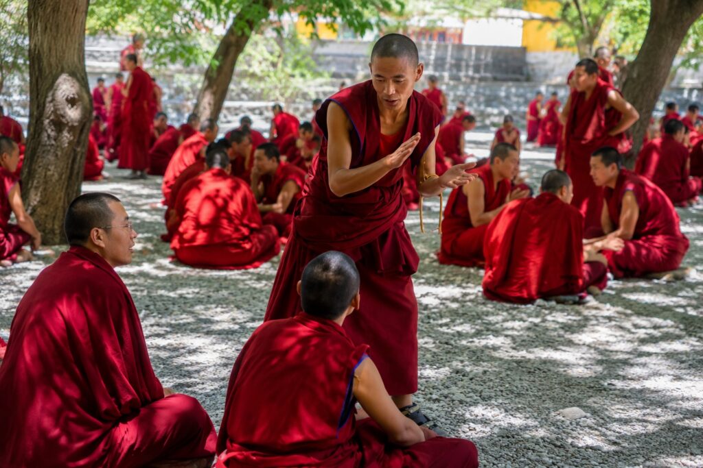 Monks engaged in a traditional debate session at Namgyal Monastery in McLeod Ganj Dharamshala