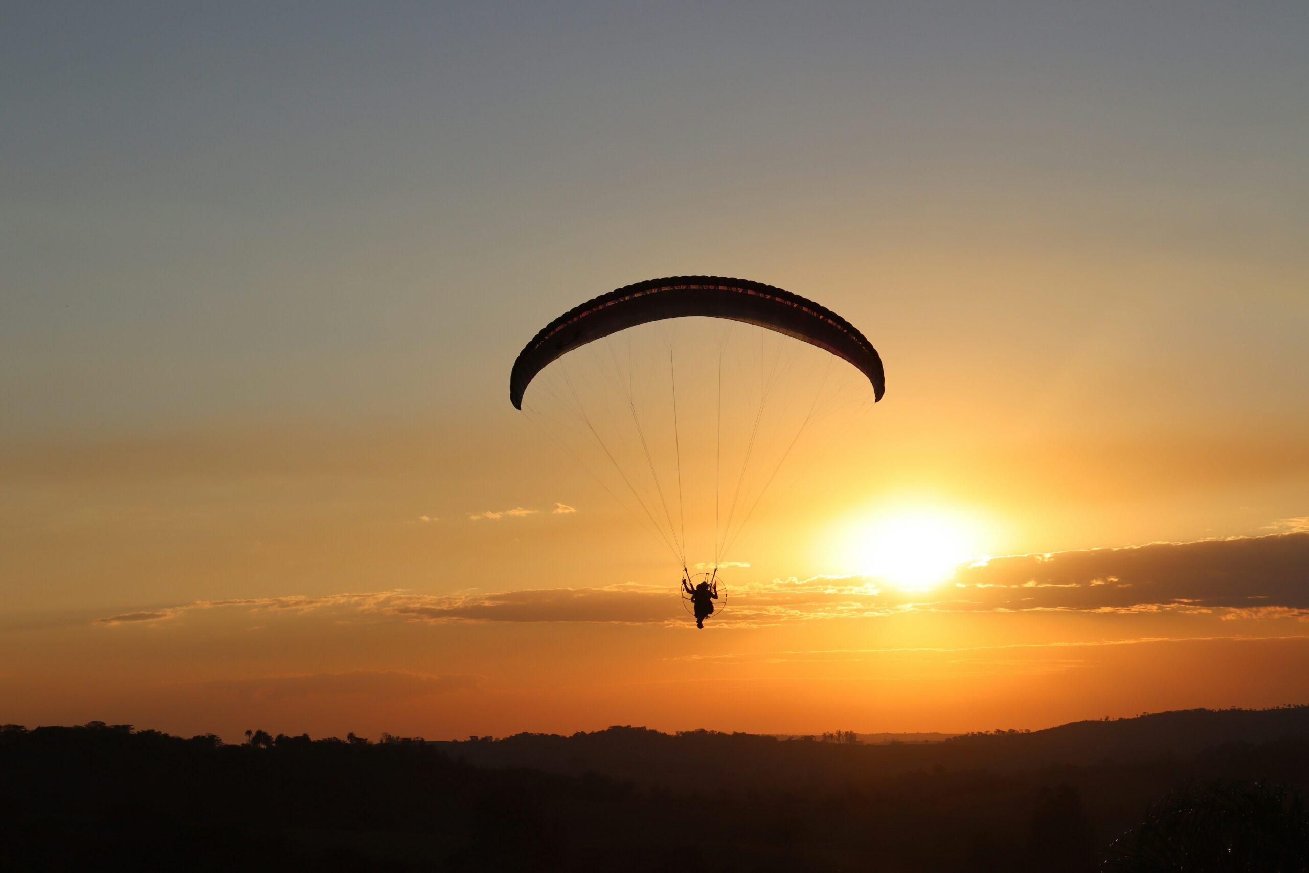 Paraglider flying at sunset over Bir Billing, one of the most popular things to do in Bir Billing, Himachal Pradesh.
