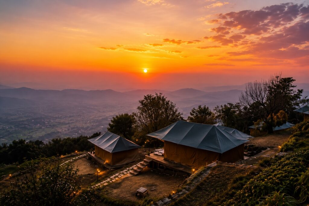 Sunset view from Chansing in Bir overlooking glamping tents, rolling hills, and the valley below, one of the most scenic things to do in Bir.